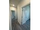 Hallway featuring doors and neutral paint throughout at 4445 America St, Orlando, FL 32811