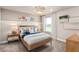 Bright bedroom with wood bed frame, stylish decor, and carpeted floor at 1983 Spring Shower Cir, Kissimmee, FL 34744