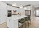 White kitchen with large island and stainless steel appliances at 1983 Spring Shower Cir, Kissimmee, FL 34744