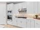 White kitchen with stainless steel appliances and a gas cooktop at 1983 Spring Shower Cir, Kissimmee, FL 34744