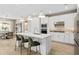 Modern kitchen with white cabinets, quartz countertops, and stainless steel appliances at 1983 Spring Shower Cir, Kissimmee, FL 34744