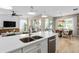 Kitchen island with sink, breakfast bar, and views into Gathering room at 1983 Spring Shower Cir, Kissimmee, FL 34744