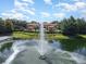 Aerial view of a large water fountain in the lake with the community clubhouse in the background at 2444 Lobelia Dr, Lake Mary, FL 32746