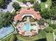 Overhead aerial view of a community pool, clubhouse and tennis court at 2444 Lobelia Dr, Lake Mary, FL 32746