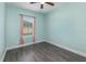 Comfortable bedroom with wood look floors, and a window for natural light at 2444 Lobelia Dr, Lake Mary, FL 32746