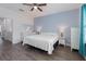 Bedroom with light blue accent wall, ceiling fan, and neutral furniture at 2444 Lobelia Dr, Lake Mary, FL 32746