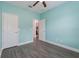 Comfortable bedroom with wood look floors and access to an ensuite bathroom at 2444 Lobelia Dr, Lake Mary, FL 32746