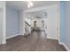 Open concept living room with hardwood floors and light blue accent wall, and gray couch at 2444 Lobelia Dr, Lake Mary, FL 32746