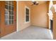 Covered patio features neutral color scheme, tile flooring, and a ceiling fan at 2444 Lobelia Dr, Lake Mary, FL 32746