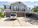 Two-story home with a gray exterior, brown garage doors, and a concrete driveway with a silver minivan and black truck at 6604 S Goldenrod Rd # 100B, Orlando, FL 32822