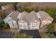 Aerial view of condo buildings with garages and neutral exteriors, surrounded by trees and parking areas at 12855 Madison Pointe Cir # 106, Orlando, FL 32821