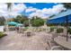 A community patio features multiple tables, chairs, umbrellas and meticulous landscaping at 12855 Madison Pointe Cir # 106, Orlando, FL 32821