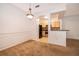 Open concept dining area with adjacent kitchen featuring black appliances and tan cabinets at 12855 Madison Pointe Cir # 106, Orlando, FL 32821