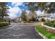 Gated community entrance showcasing manicured landscaping, wrought iron gates and well maintained buildings at 12855 Madison Pointe Cir # 106, Orlando, FL 32821