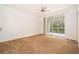 The living room features carpet flooring and sliding glass doors that lead to a screened in lanai at 12855 Madison Pointe Cir # 106, Orlando, FL 32821