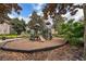 Community playground area with a slide, climbing structures, and bordered with fresh mulch at 12855 Madison Pointe Cir # 106, Orlando, FL 32821