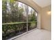 Screened patio overlooking the greenery and shrubbery at 12855 Madison Pointe Cir # 106, Orlando, FL 32821