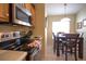 Kitchen with stainless steel appliances and adjacent dining nook at 320 Henley Cir, Davenport, FL 33896