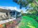 Screened porch and grassy backyard with mature trees at 648 Brechin Dr, Winter Park, FL 32792