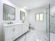 Modern bathroom with double vanity, marble floors, and a large shower at 648 Brechin Dr, Winter Park, FL 32792