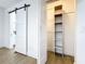 White closet with sliding barn door and shelving at 648 Brechin Dr, Winter Park, FL 32792