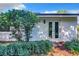 Rear exterior view showing white painted walls and lush landscaping at 648 Brechin Dr, Winter Park, FL 32792