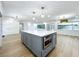 Kitchen island with white quartz countertop and gray cabinets at 648 Brechin Dr, Winter Park, FL 32792