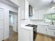 White kitchen with stainless steel appliances and farmhouse sink at 648 Brechin Dr, Winter Park, FL 32792