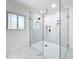 Large walk-in shower with marble tile and gold fixtures at 648 Brechin Dr, Winter Park, FL 32792