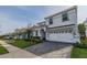 Beautiful white two-story home boasting a paved driveway, attached two car garage and lush landscaping in a desirable location at 1548 Moon Valley Dr, Davenport, FL 33896