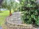 Paver patio area surrounded by lush landscaping creating a private outdoor space at 5610 King James Ave, Leesburg, FL 34748