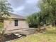 Backyard with patio, landscaping, and a palm tree at 5610 King James Ave, Leesburg, FL 34748