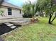 Backyard with stone patio, lawn, and landscaping at 5610 King James Ave, Leesburg, FL 34748