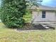Small backyard with patio and partially visible landscaping at 5610 King James Ave, Leesburg, FL 34748