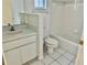 Bright bathroom with white vanity, toilet, and bathtub at 5610 King James Ave, Leesburg, FL 34748