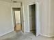 View of bedroom, with carpets, closets and adjacent room at 5610 King James Ave, Leesburg, FL 34748