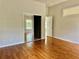 Cozy bedroom features hardwood floors and a mirrored closet, blending style and practicality at 5610 King James Ave, Leesburg, FL 34748