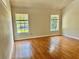 Comfortable bedroom with gleaming hardwood floors and ample natural light at 5610 King James Ave, Leesburg, FL 34748