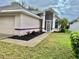 Inviting home featuring well-maintained landscaping, a screened front entry, and a neatly kept lawn at 5610 King James Ave, Leesburg, FL 34748