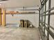 Spacious garage with storage shelves and an open garage door at 5610 King James Ave, Leesburg, FL 34748