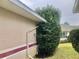 Side view of the house showcasing landscaping and gutters at 5610 King James Ave, Leesburg, FL 34748