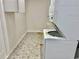 Well-lit laundry room with stackable washer and dryer at 5610 King James Ave, Leesburg, FL 34748