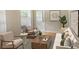 Inviting living room with stylish seating, plants, and an eye-catching painting creating a serene ambiance at 5610 King James Ave, Leesburg, FL 34748