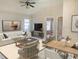 Spacious living room with tile floors and open floorplan has comfortable seating and neutral colors, allowing for natural light at 5610 King James Ave, Leesburg, FL 34748