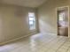 Living room featuring tile flooring and access to other rooms at 5610 King James Ave, Leesburg, FL 34748