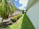 Well-maintained side yard featuring lush greenery and a neatly trimmed lawn at 5610 King James Ave, Leesburg, FL 34748