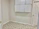 Clean storage room with white cabinets and patterned floor at 5610 King James Ave, Leesburg, FL 34748