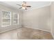 Well-lit bedroom with carpeted floor and ceiling fan at 31722 Red Tail Blvd, Sorrento, FL 32776