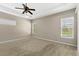 Well-lit bedroom with dual windows and ceiling fan at 31722 Red Tail Blvd, Sorrento, FL 32776