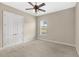 Bright bedroom with carpeted floors and double door closet at 31722 Red Tail Blvd, Sorrento, FL 32776